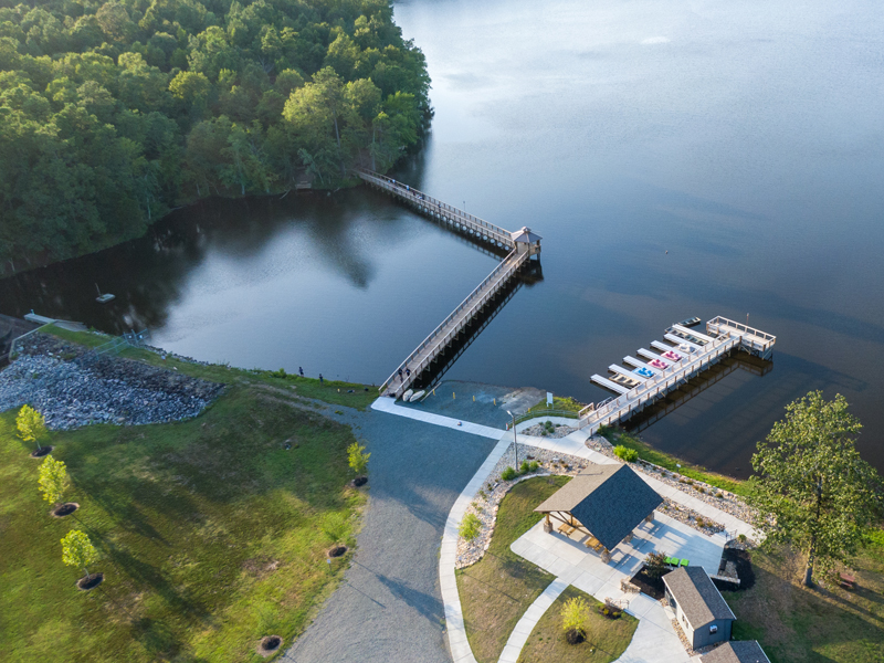 Overhead view of lake rogers park, including dock, gazebo, covered seating area, bathrooms, and nature trail entrance.