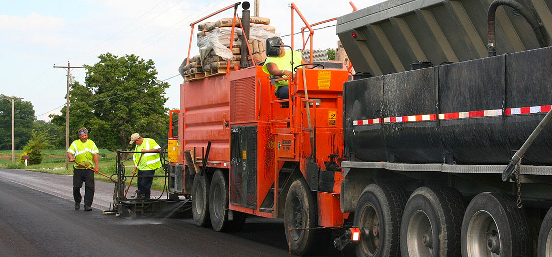 Summit workers apply a surface coat of sealant for the Raleigh pavement preservation.