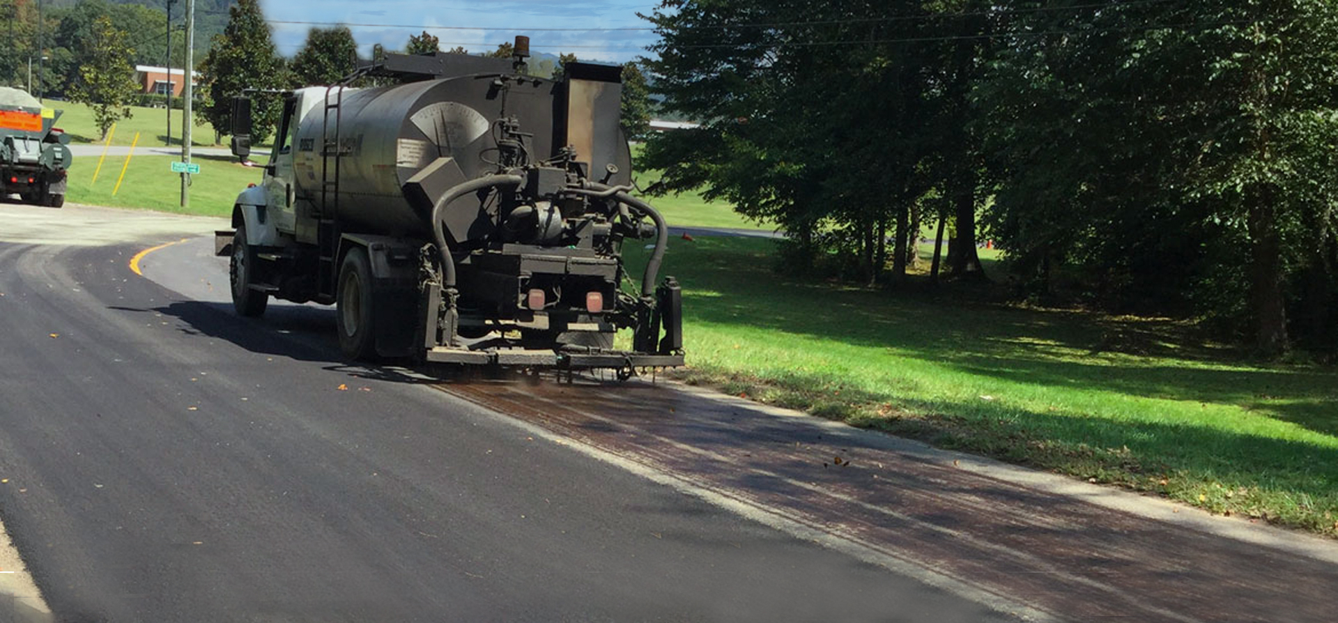 A vehicle applying roadway treatment to the asphalt as part of the Raleigh pavement preservation.