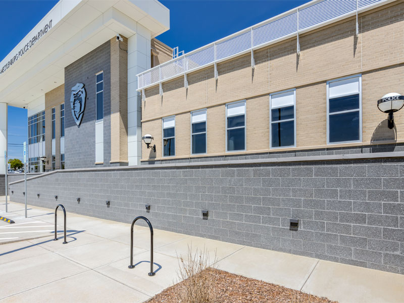 CMPD independence station brickwork and building facade with sidewalk laid out before it.
