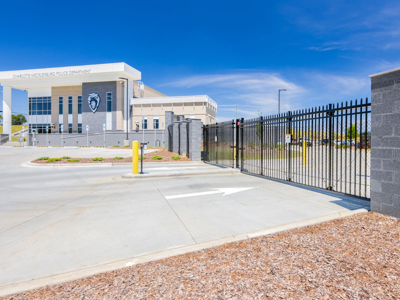 Photograph of the CMPD independence station gate leading to the larger employee parking lot.