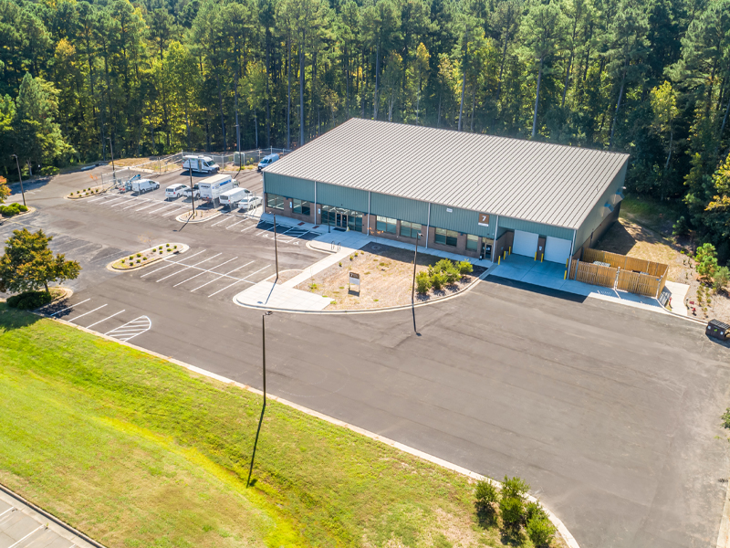 Durham Tech Facility from an angle, showing the asphalt and back side of the building.