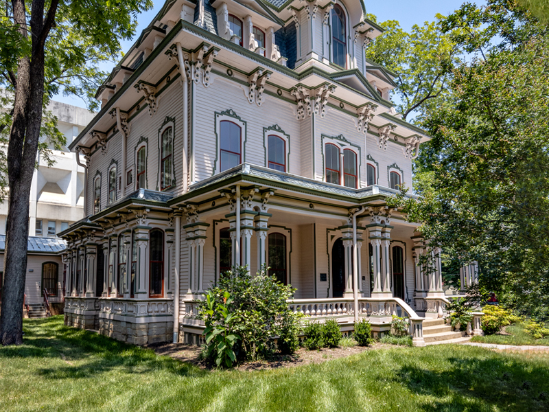 Heck-Andrews House Renovation photo featuring the rear façade of the building, including the yard, steps, and three stories.