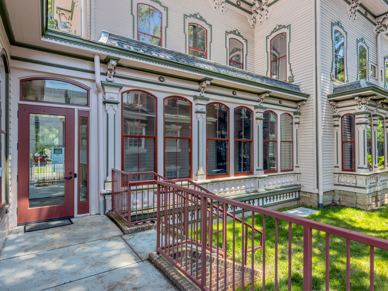 Heck-Andrews House Renovation photo from the porch showing the yard, back windows, and architecture.