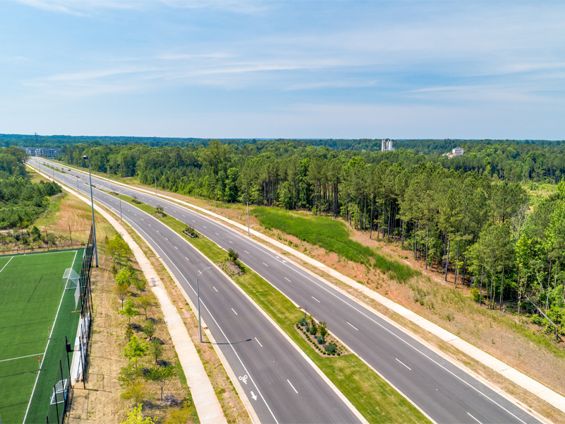 photo of the McCrimmon Parkway bordered by trees and recreational sports fields.