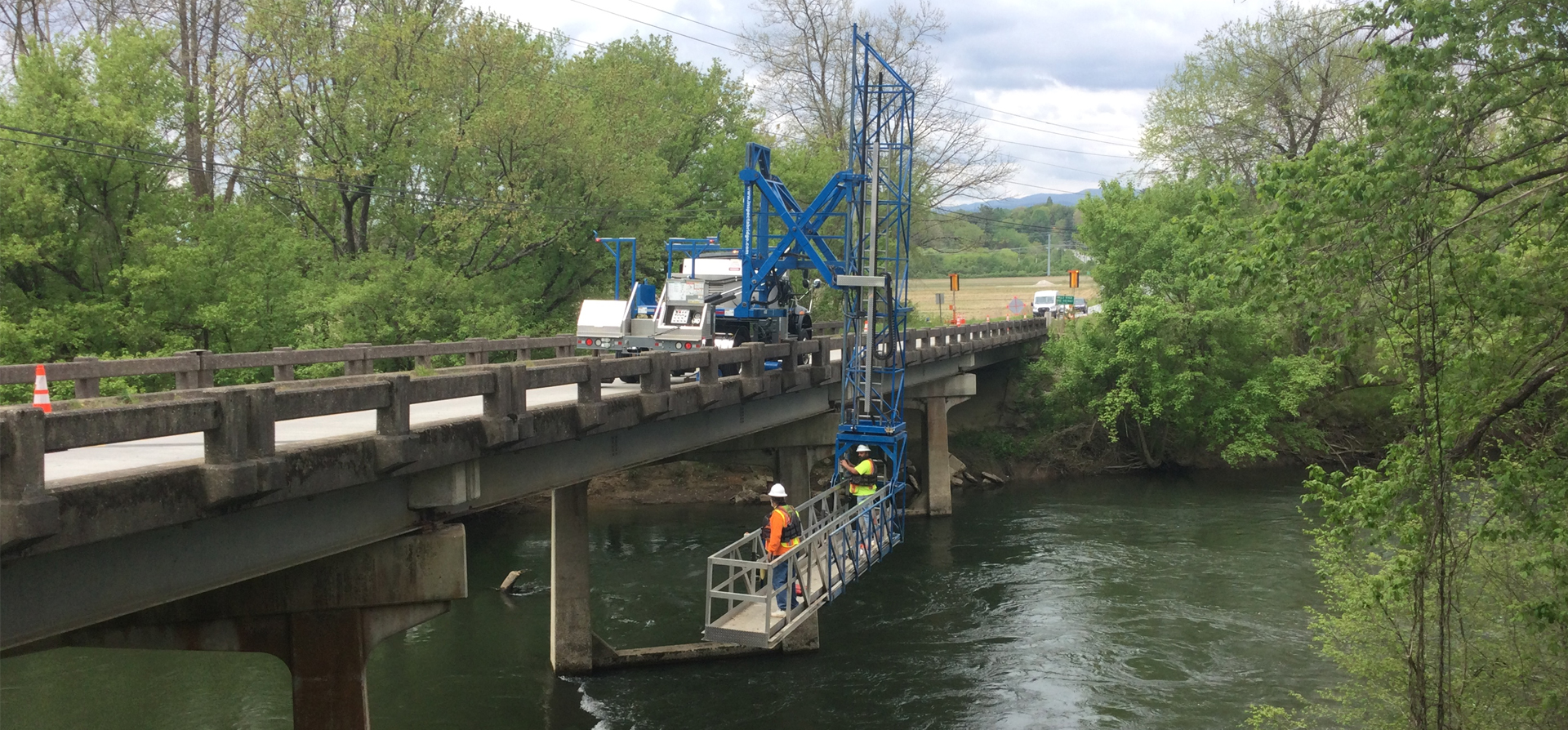 Work being done on a bridge by a construction inspection team.