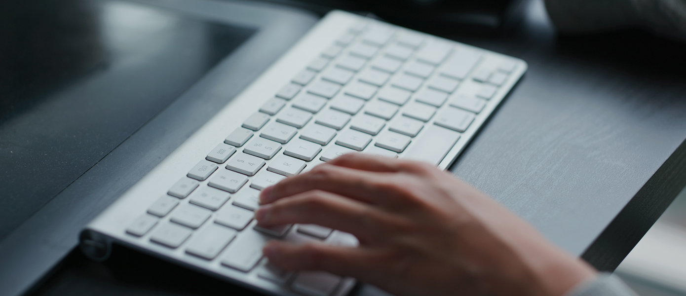 Person with hand on keyboard